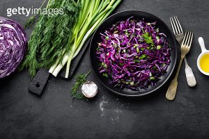 Red cabbage salad with fresh green onion and dill. Vegetarian dish.